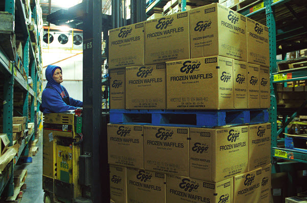 person operating a forklift with food boxes on it
