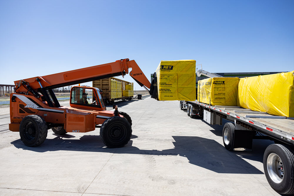 a vehicle loading cargo onto a trailer