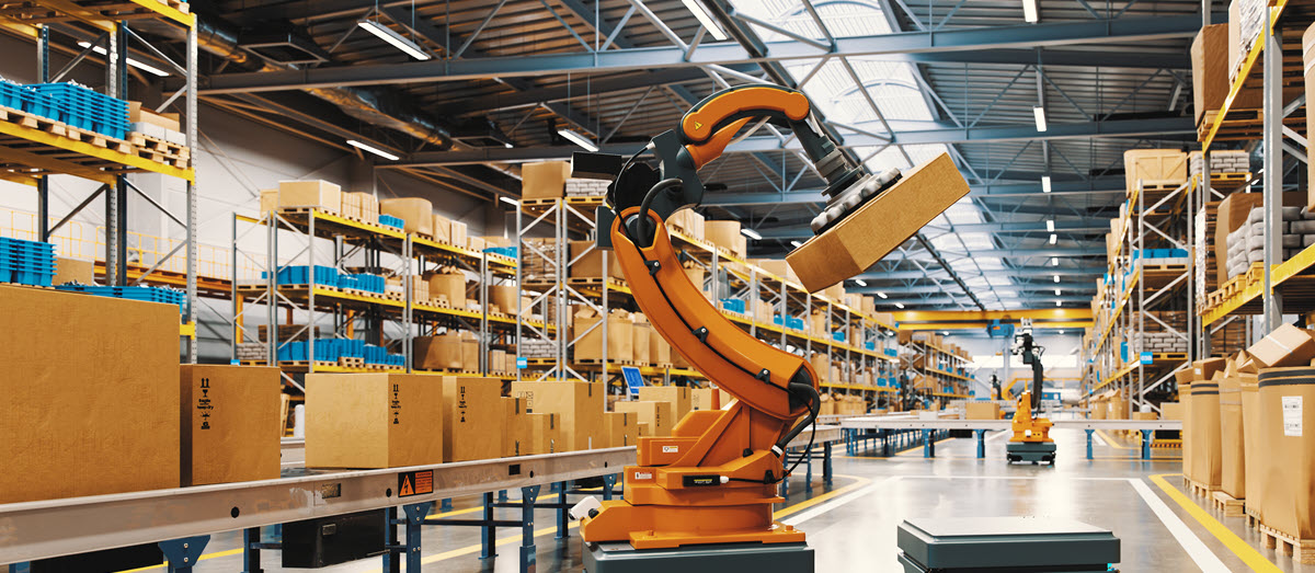 manufacturing facility with a robot arm moving boxes