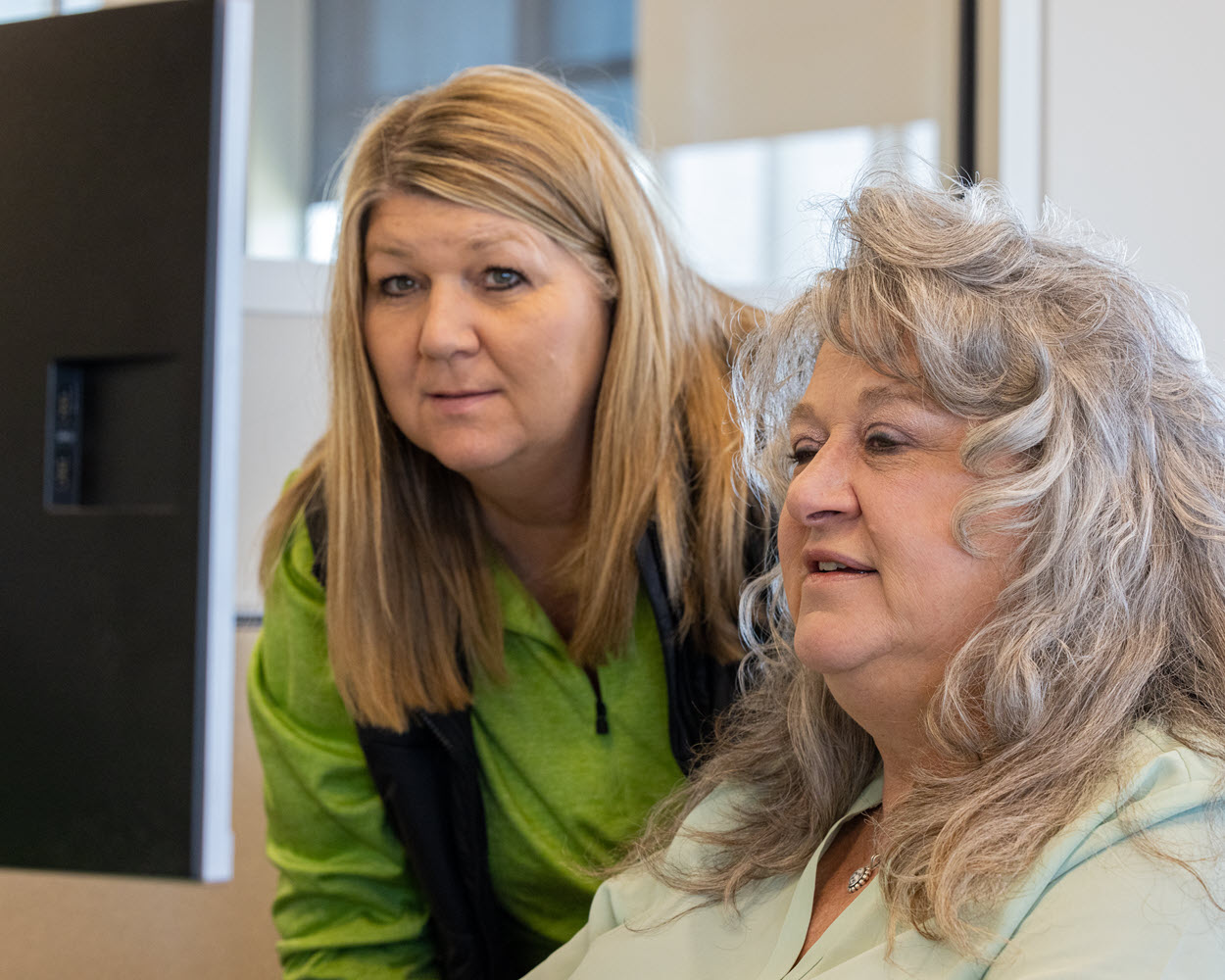 two team members reviewing freight logistics at a workstation