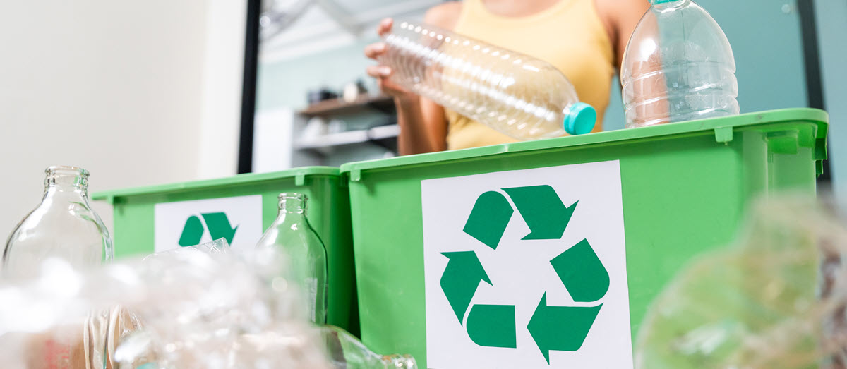 woman recycling plastic bottles