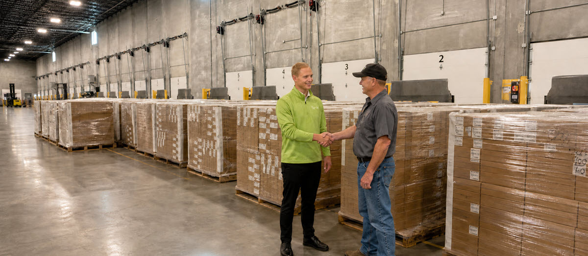 Travero employee and carrier shaking hands